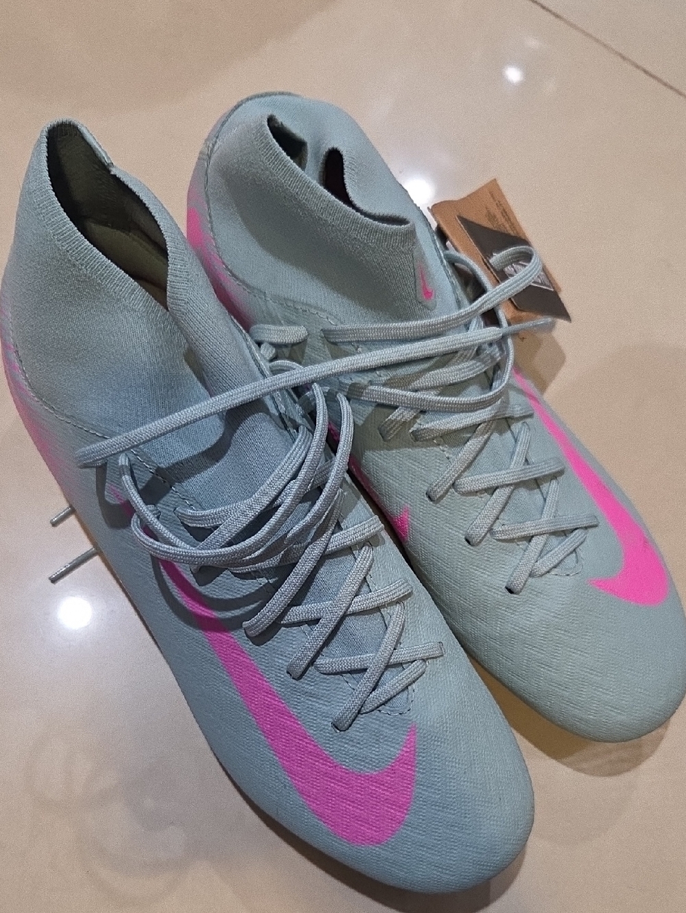 Nike Women's Light Gray Soccer Cleats with Pink Swoosh